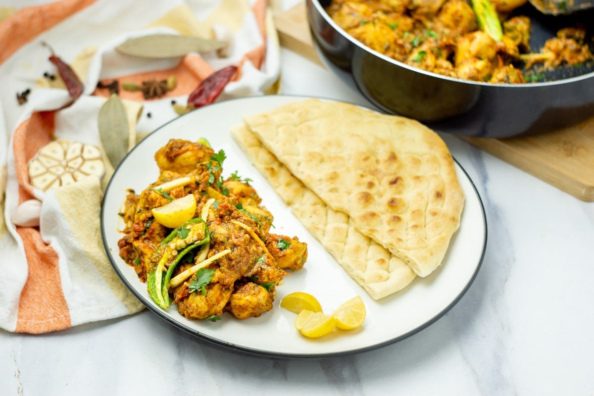 Chicken Karahi in a white plate with naan