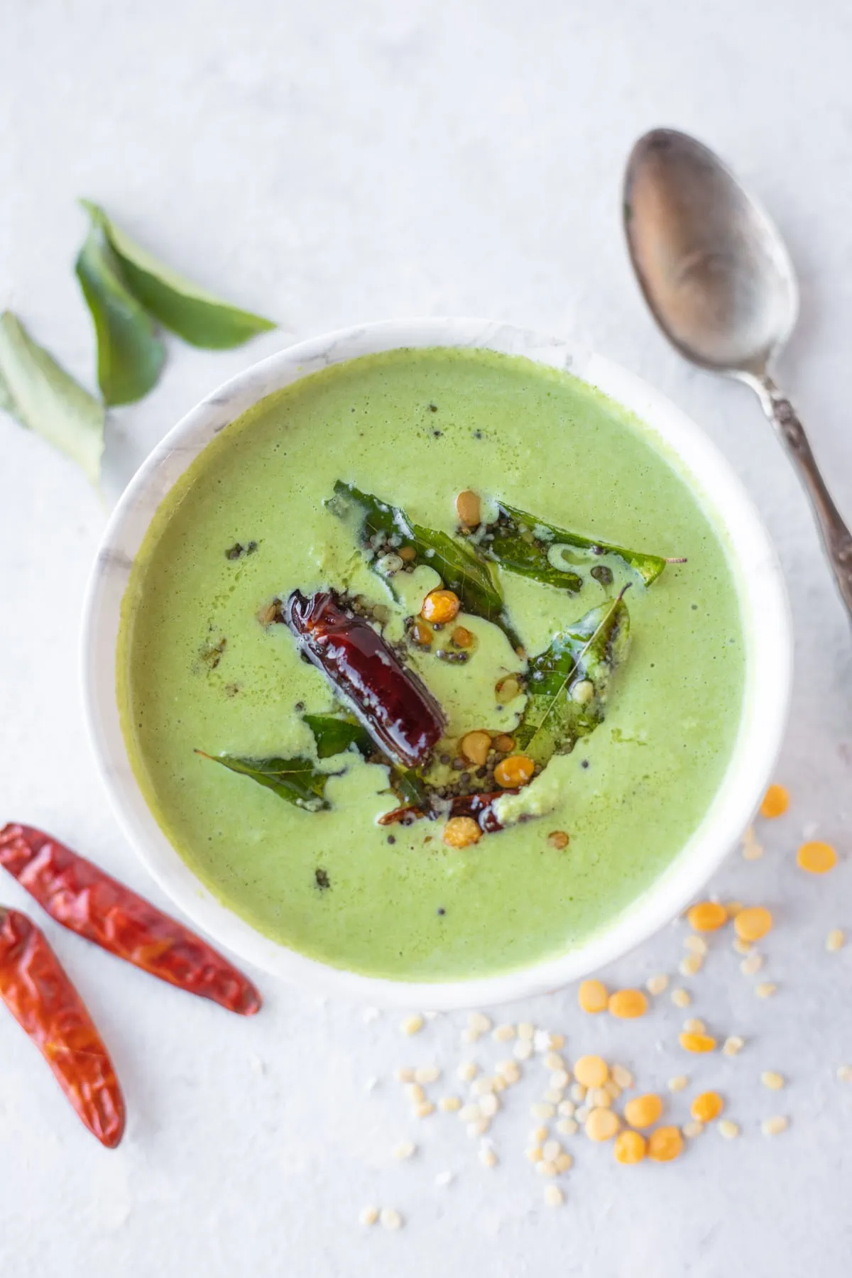 Green Coconut Chutney with spoon on the side