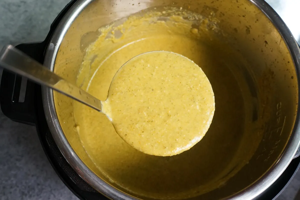 Cream of broccoli soup made in the instant pot in a ladle