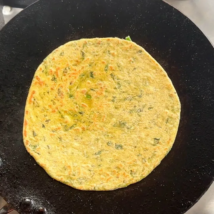 flip the paratha and cook