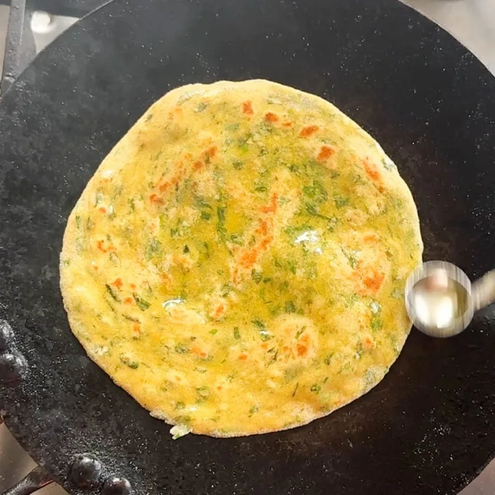 spread ghee to the paratha