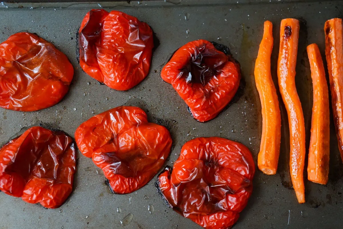 Roasted red peppers and carrots on a baking tray