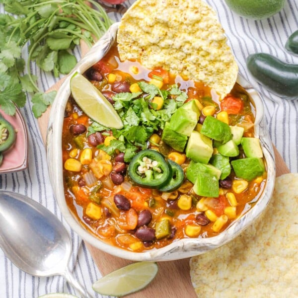 Vegetarian Taco Soup in a bowl garnished with jalapeños, avocado and cilantro.