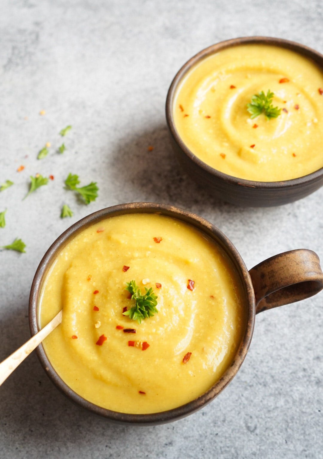 Turmeric Cauliflower Soup made in the instant pot in a bowl topped with red chili flakes