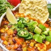 Vegetarian Taco Soup in a bowl topped with jalapeno and avocado