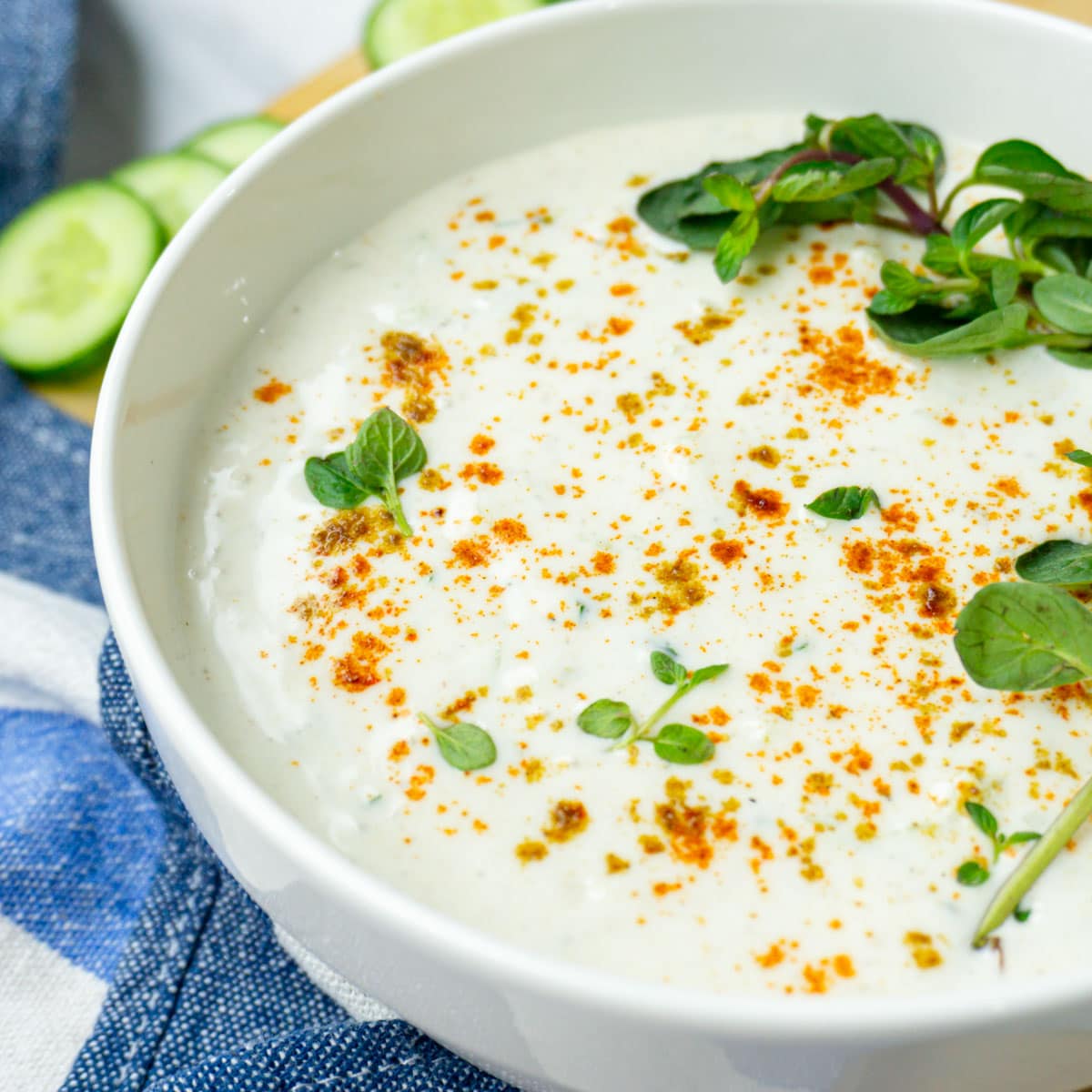 refreshing cucumber raita in a white bowl