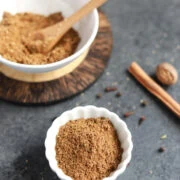 Garam masala spice powder in a small white bowl
