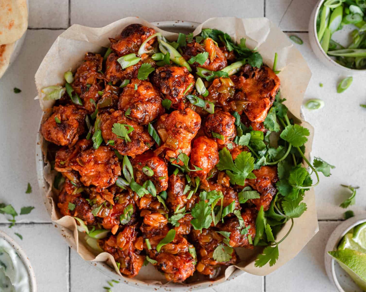 Gobi manchurian in a bowl garnished with green onions