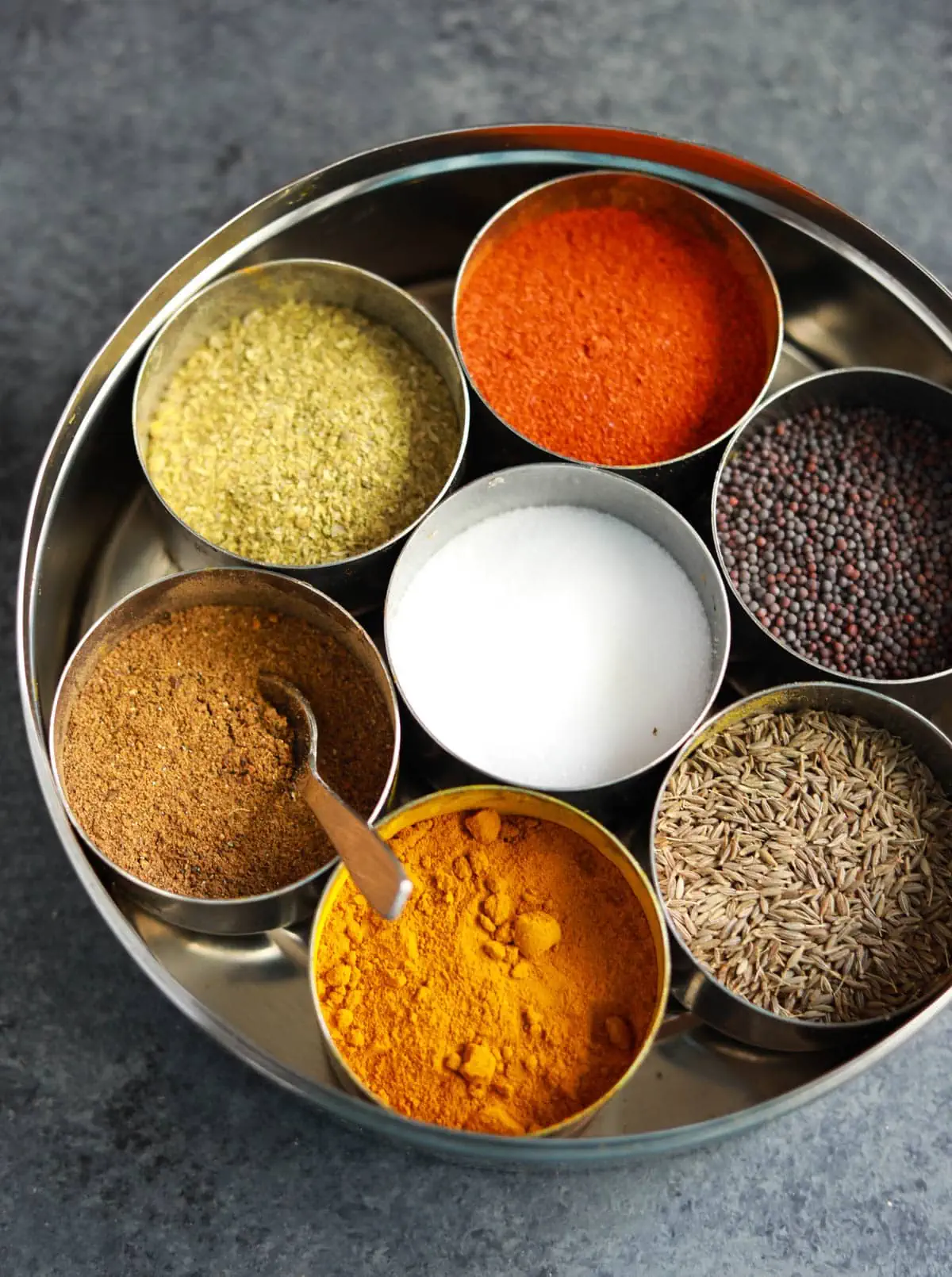 Spices nicely organized in an indian spice box, called masala dabba