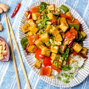 vegan Kung Pao Tofu Chinese style in a plate with chopsticks on the side