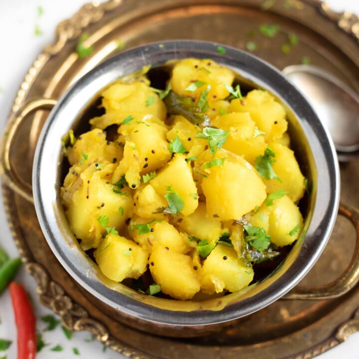 Potato Masala (batata bhaji) in a pretty bowl topped with cilantro leaves