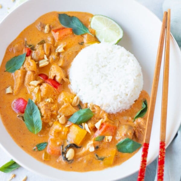 Thai panang curry chicken with rice and chop stick on the side