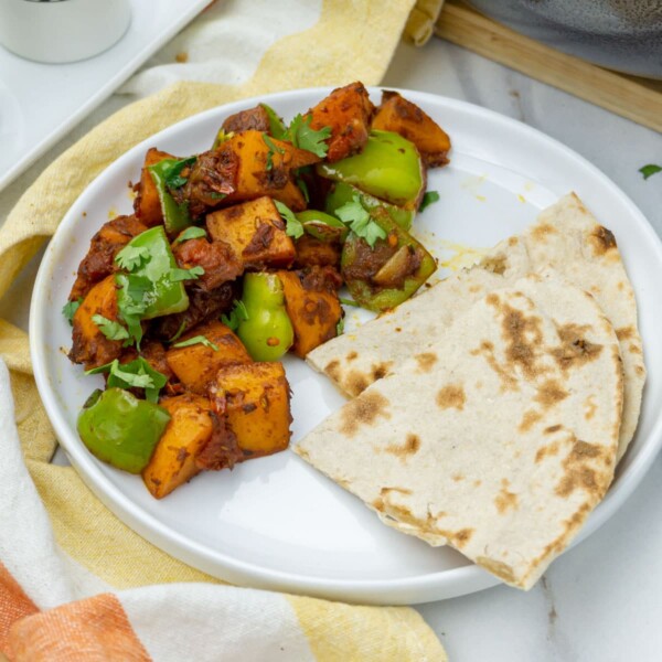 Aloo Simla Mirch (Potato & Bell Pepper Stir Fry) with roti in a plate