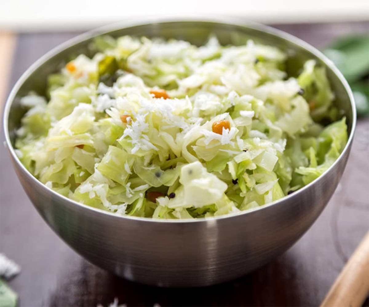 Cabbage poriyal in a steel bowl