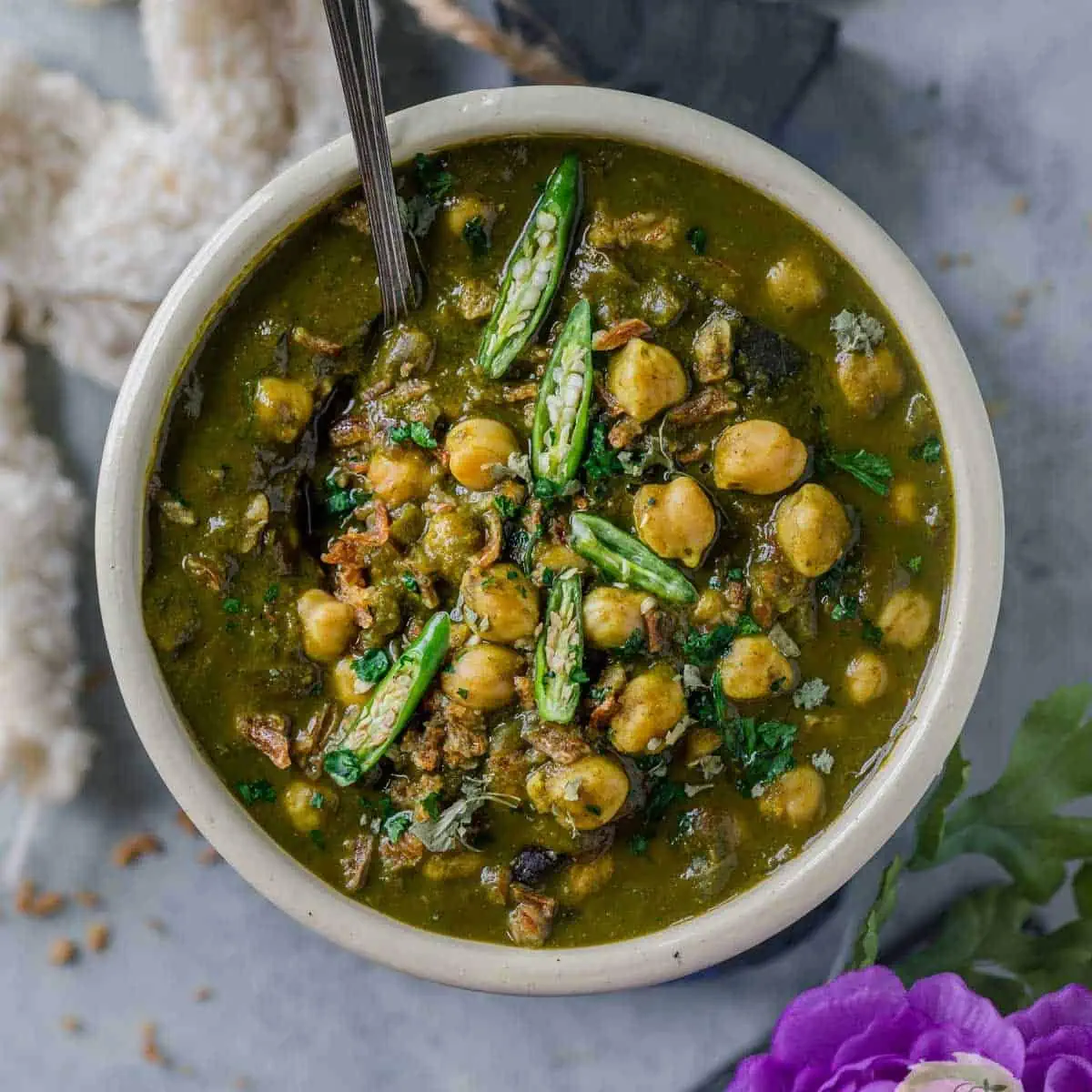 Chana Palak served in a bowl with a spoon in it