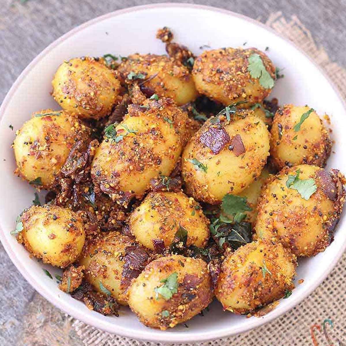 Chettinad Potato fry in white bowl