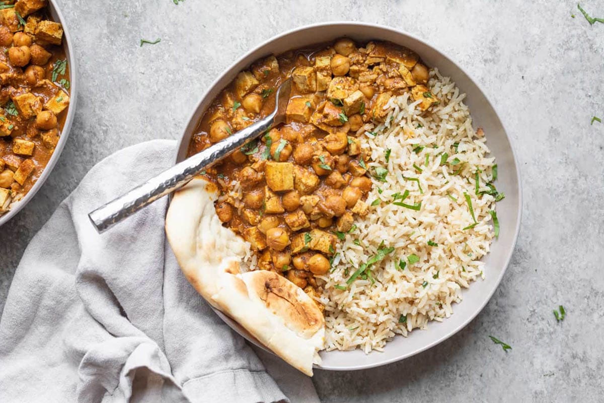 Slow Cooker Butter Chickpeas in a bowl with Naan