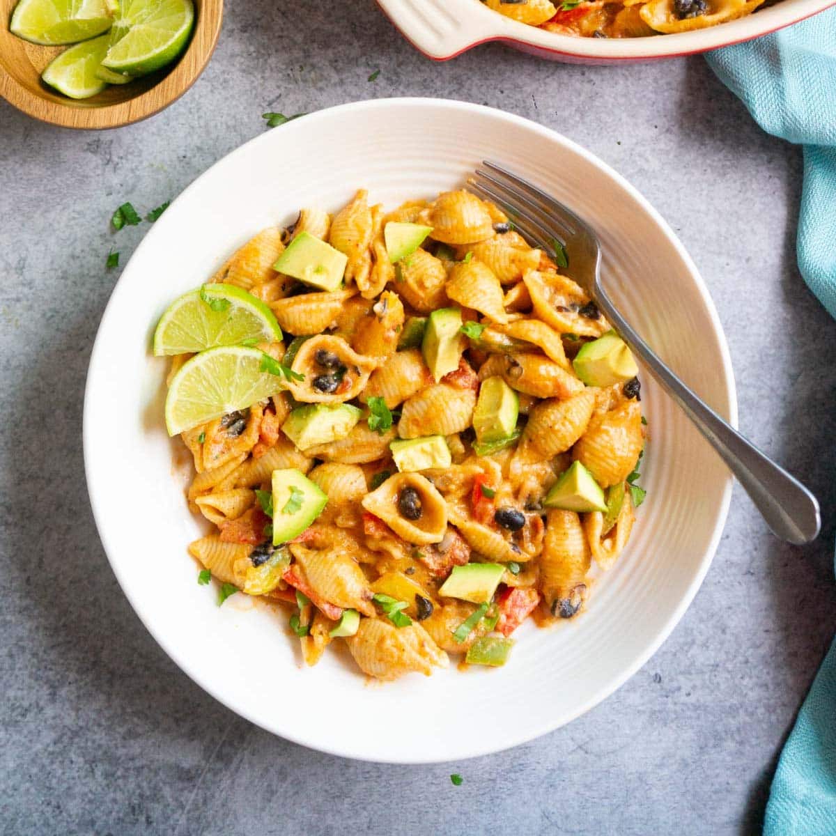 Fajita pasta with black beans in a bowl topped with avocado