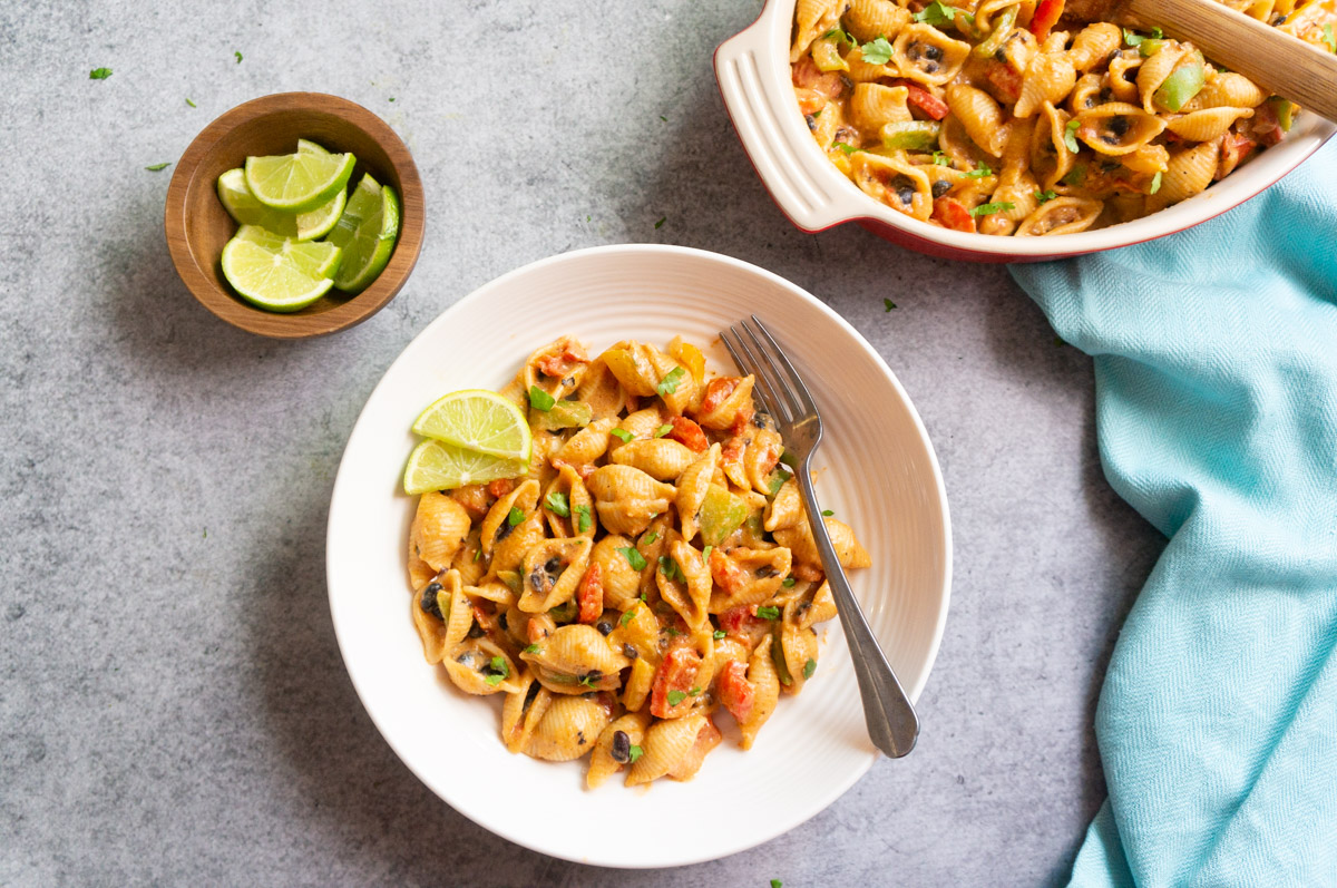 Fajita pasta served in a bowl topped with avocado