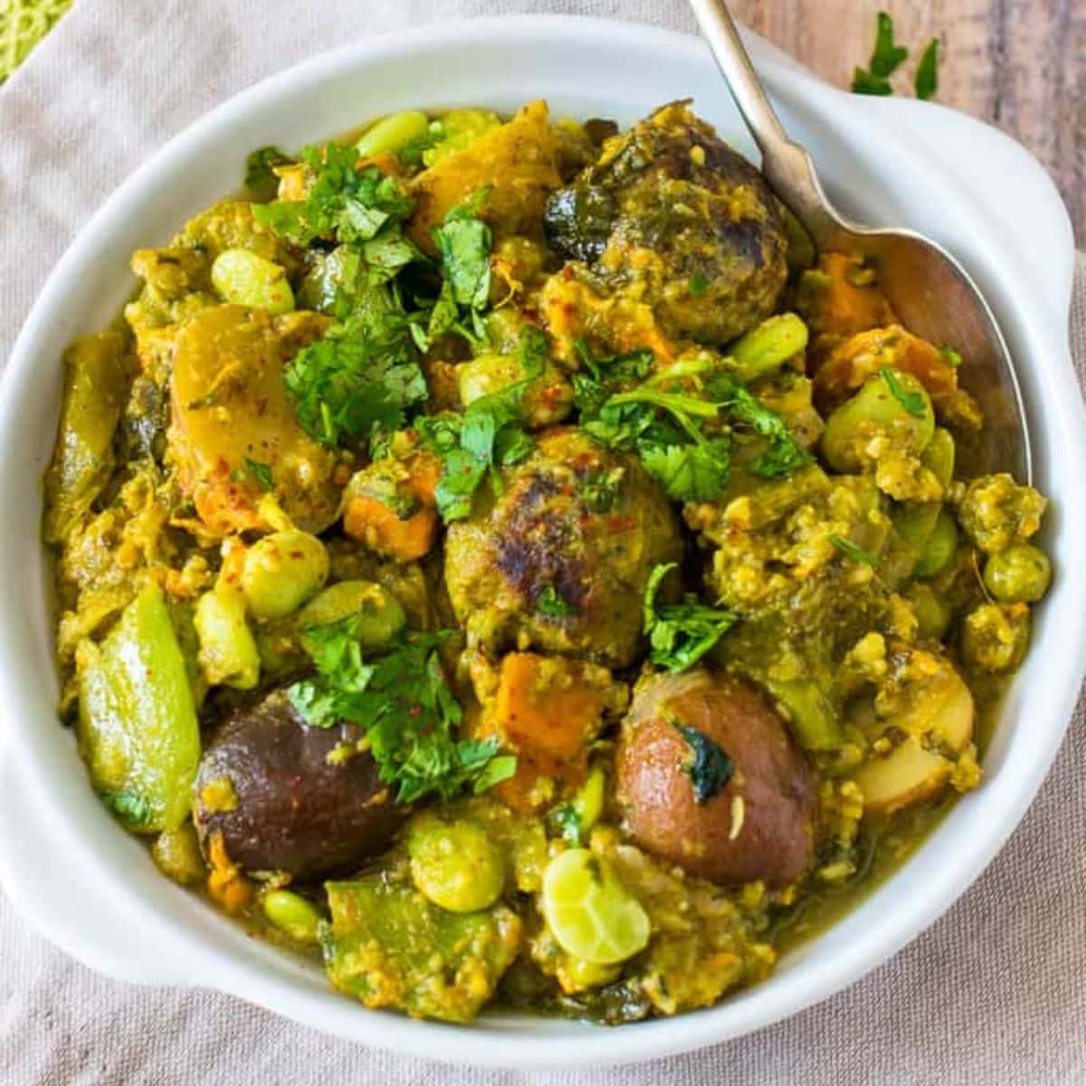 Gujarati Undhiyu in a bowl with spoon