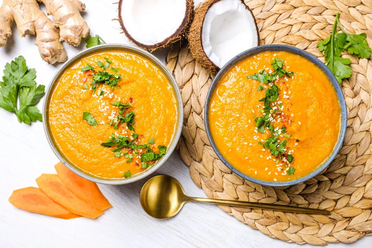 Carrot soup served in 2 blows garnished with cilantro 