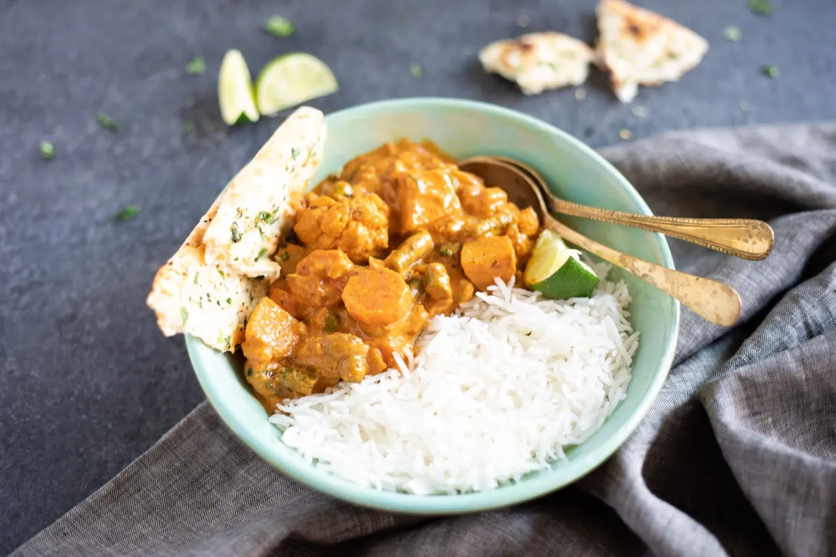 Vegetable Korma served with rice in a bowl