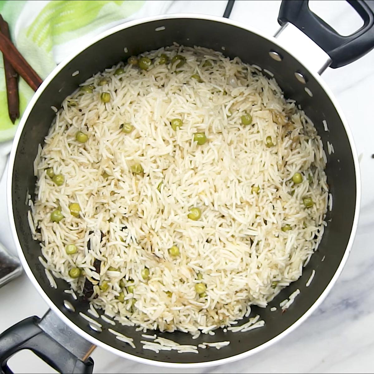 Cooked Matar Pulao in a black nonstick pot