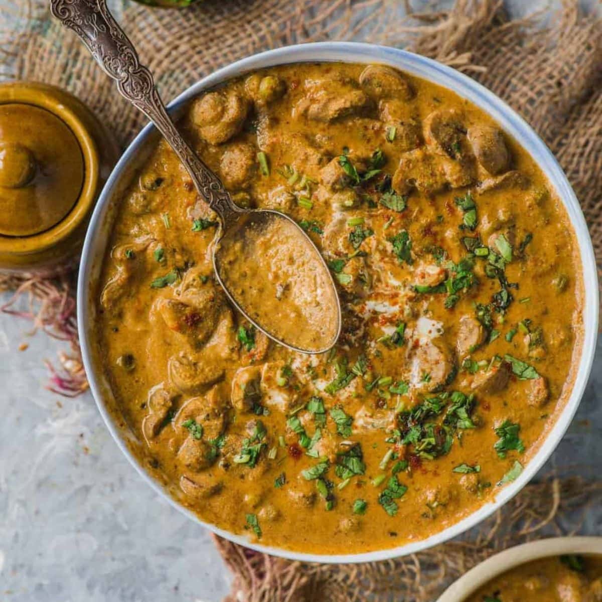 Mushroom masala in a bowl with spoon