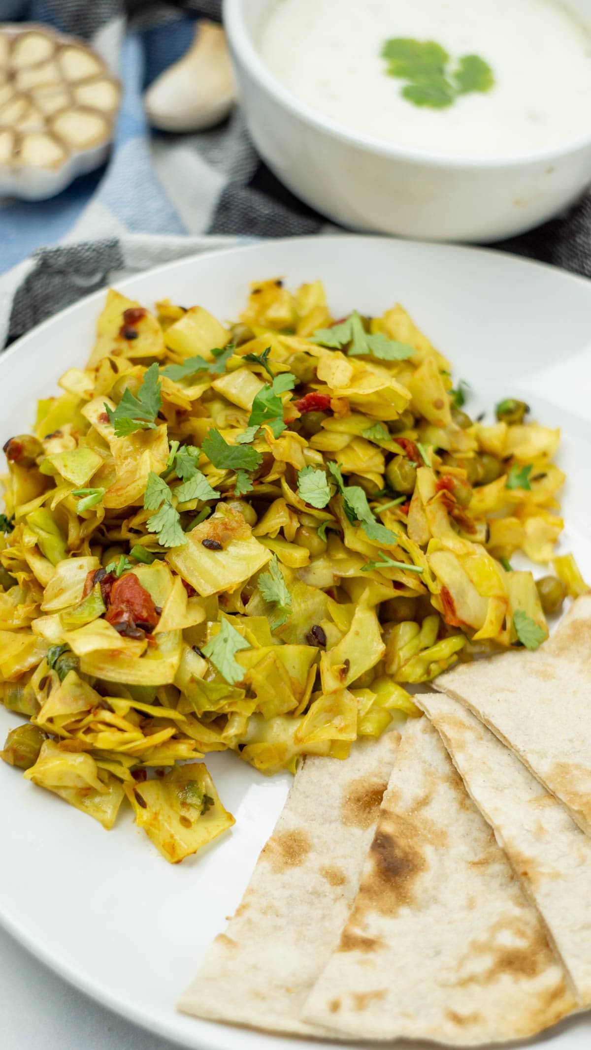 Cabbage peas (patta gobi matar) in a plate served with roti