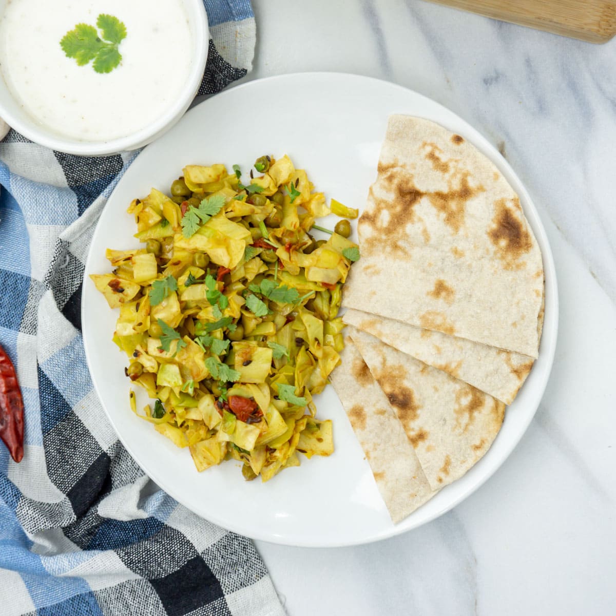 Cabbage peas (patta gobi matar) in a plate with roti