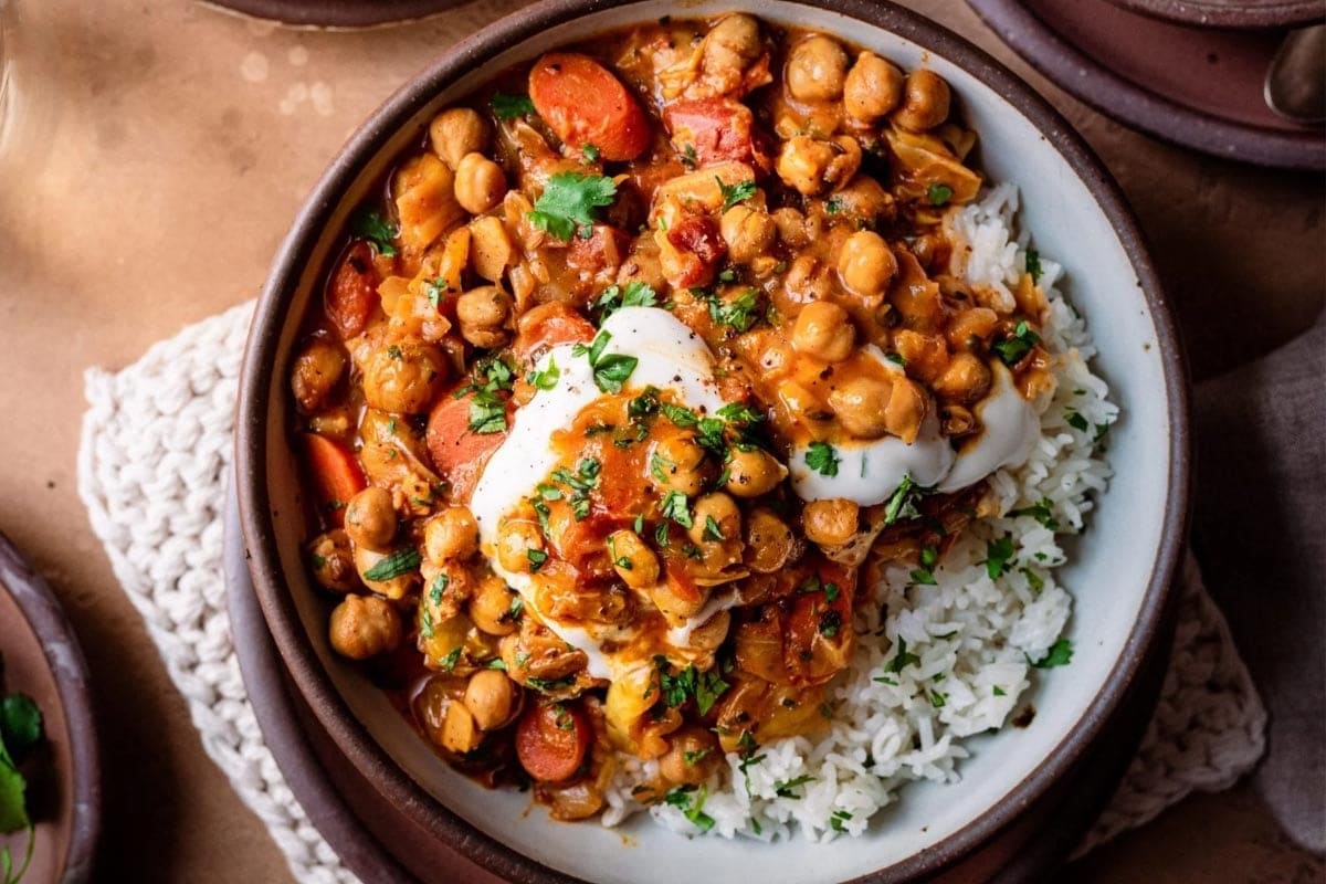 braised indian chickpea stew in bowl with yogurt