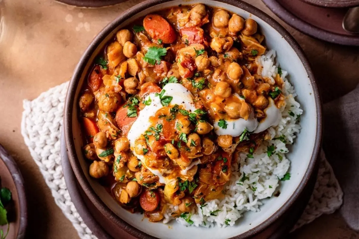 braised indian chickpea stew in bowl with yogurt