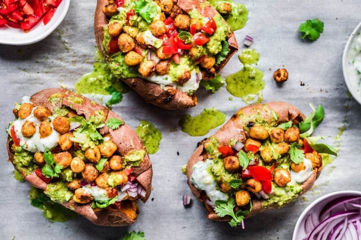 three sweet potatoes stuffed with tandoori chickpeas