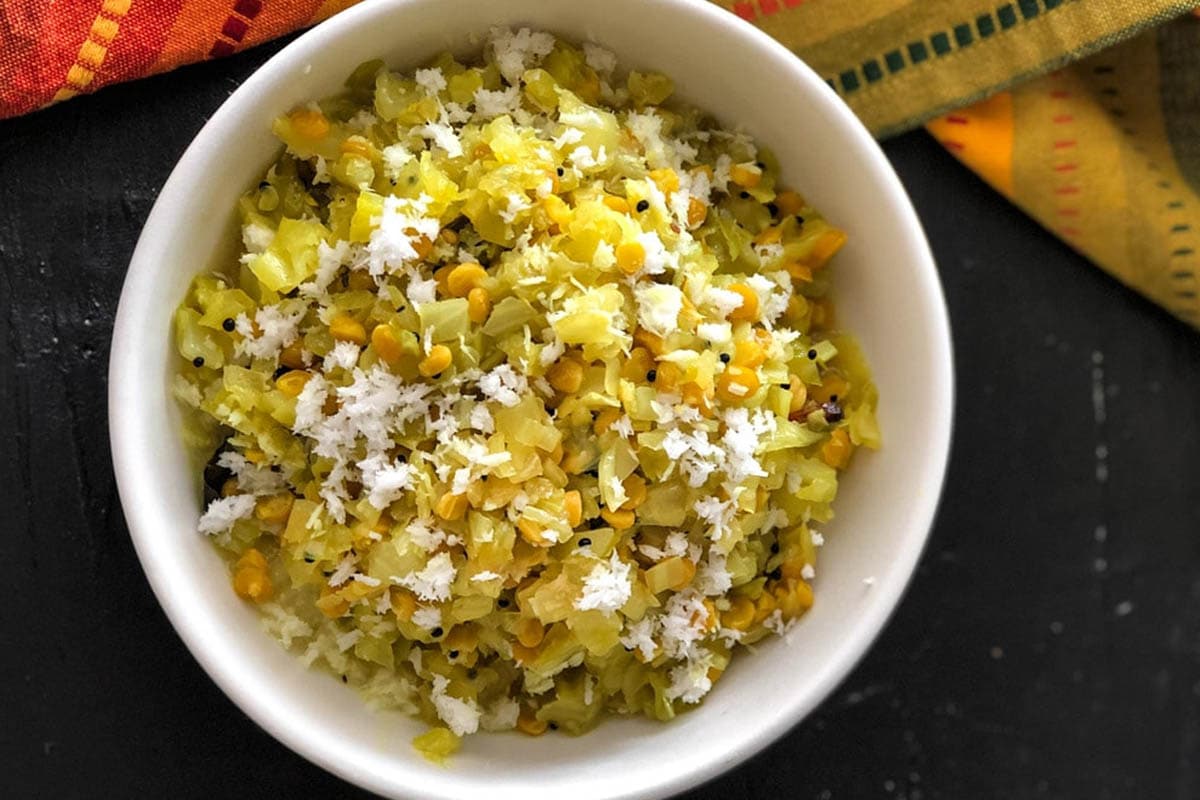 An overhead shot of cabbage kootu served in a white bowl