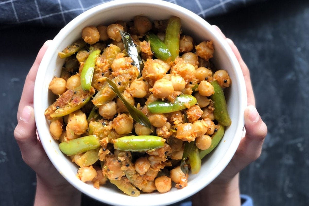 A child holding a bowl of chana tendli