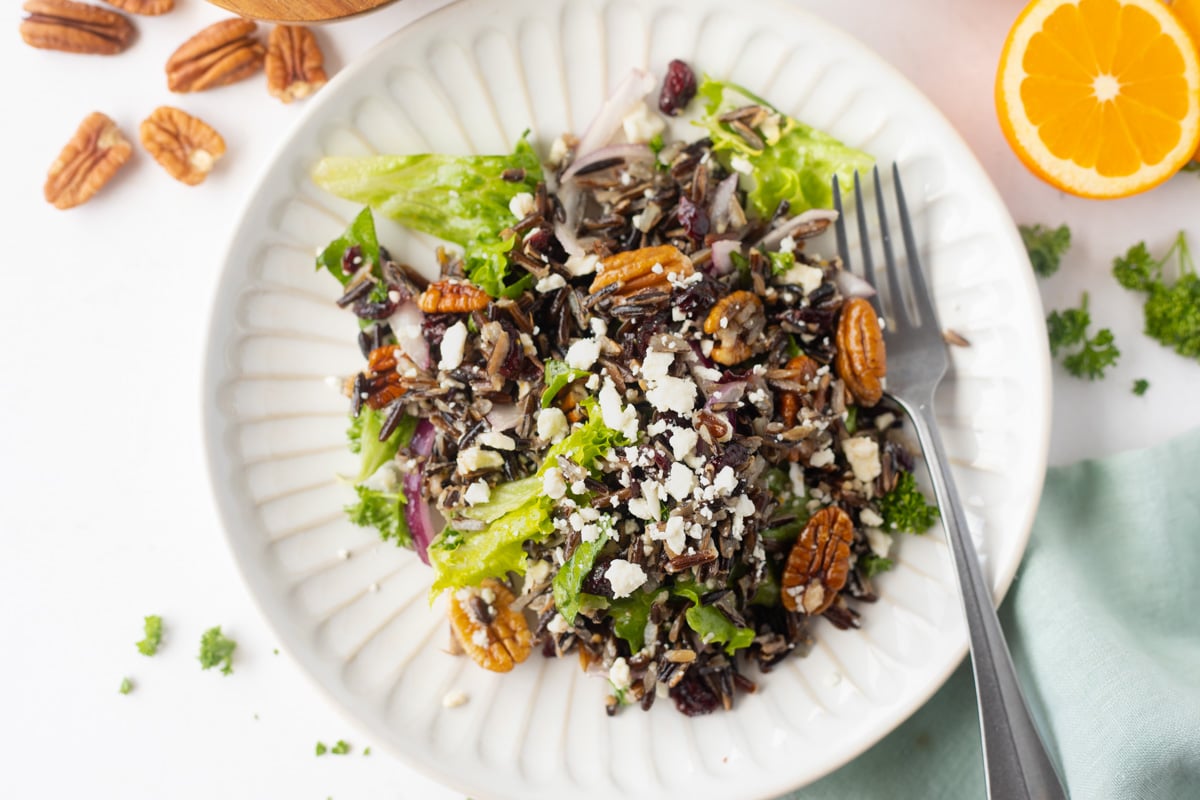 Wild Rice Salad on a white plate with fork