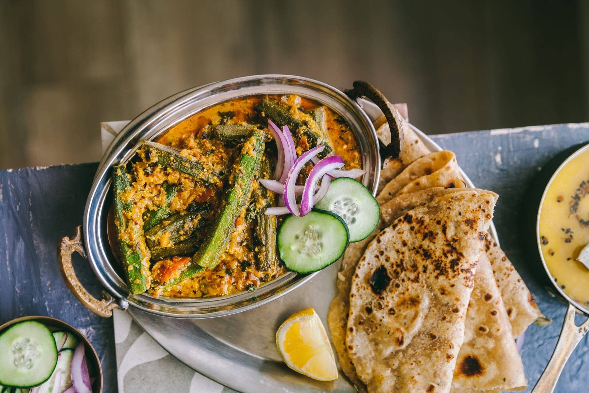 Bhindi Masala gravy in a bowl served with roti.