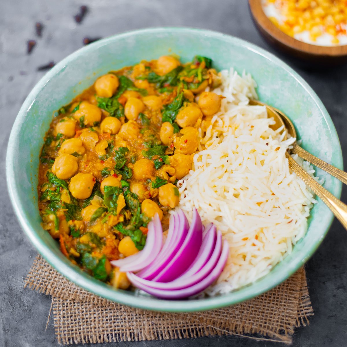 instant pot chickpea curry with spinach in a bowl with rice.