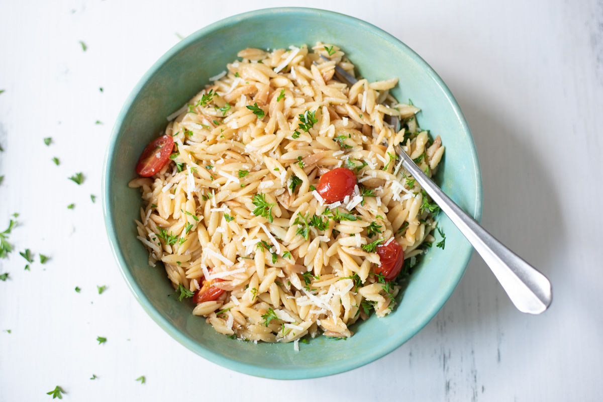 orzo with tomato and parsley in a bowl 
