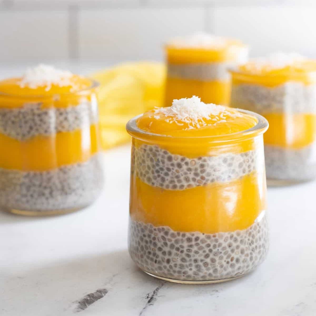 Chia seed pudding layered with mango pudding in individual serving jars. 
