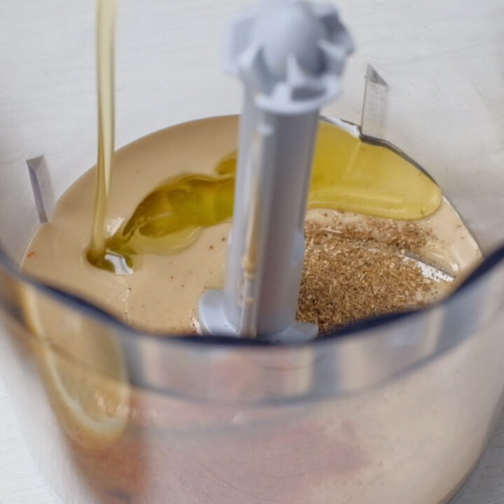 add olive oil to the food processor