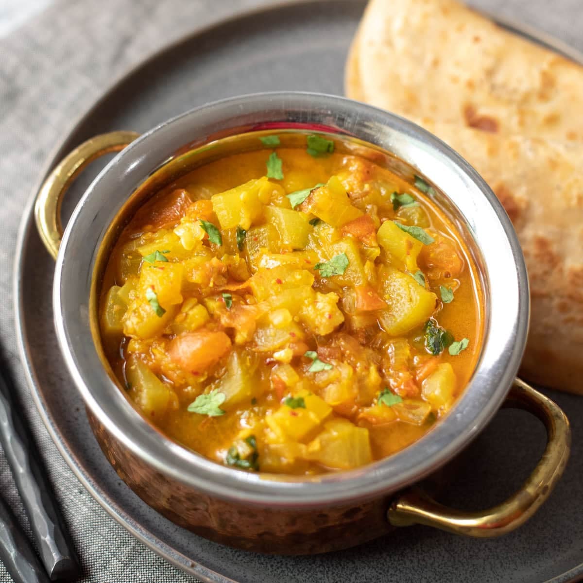 The BEST collection of 29 Instant Pot Indian Vegetarian Recipes from the best Indian food blogs! You can find a variety of vegetarian curries, lentils, beans and rice recipes from all over India. Lauki curry in a bass bowl