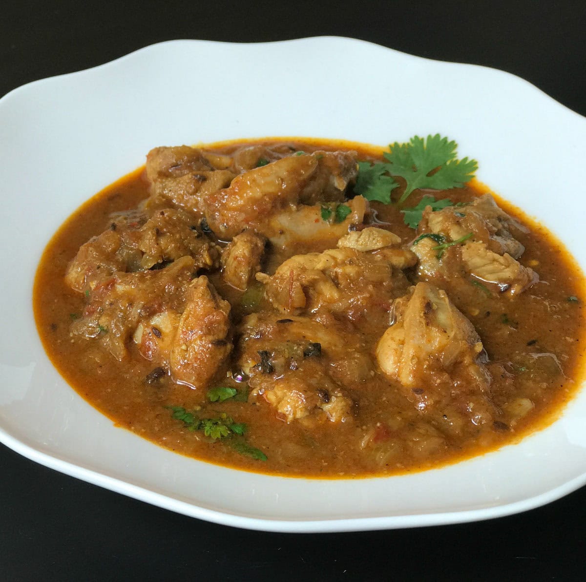 Mom's Chicken curry served in a white bowl