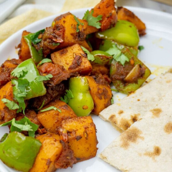 Deliciously cooked Stir fry Potato Simla Mirch in a white plate
