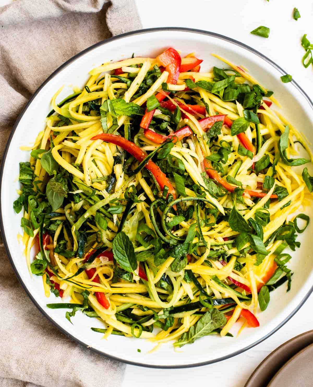 Thai mango salad in a white plate 