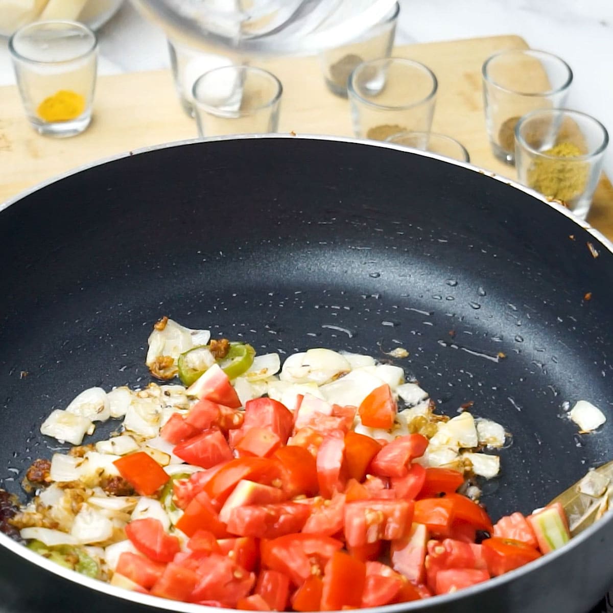 Soften tomatoes, allowing their tangy juices to infuse the curry.