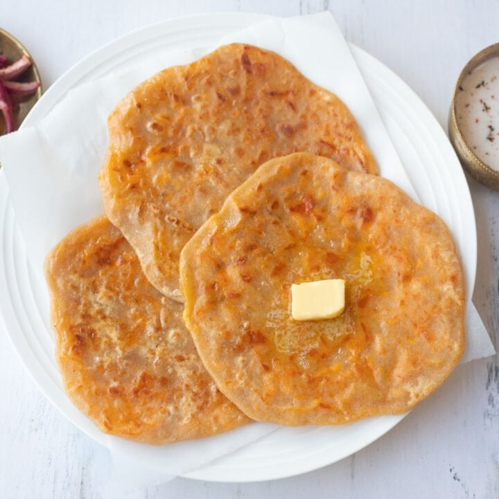 three cheese paratha in a plate with butter