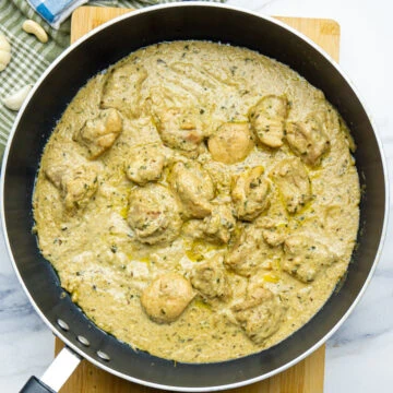 Malai chicken curry in white gravy in a pan