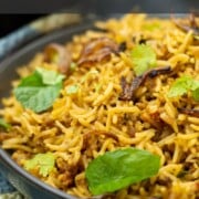 Keema Pulao, with aromatic basmati rice and minced meat, garnished with fresh mint leaves.