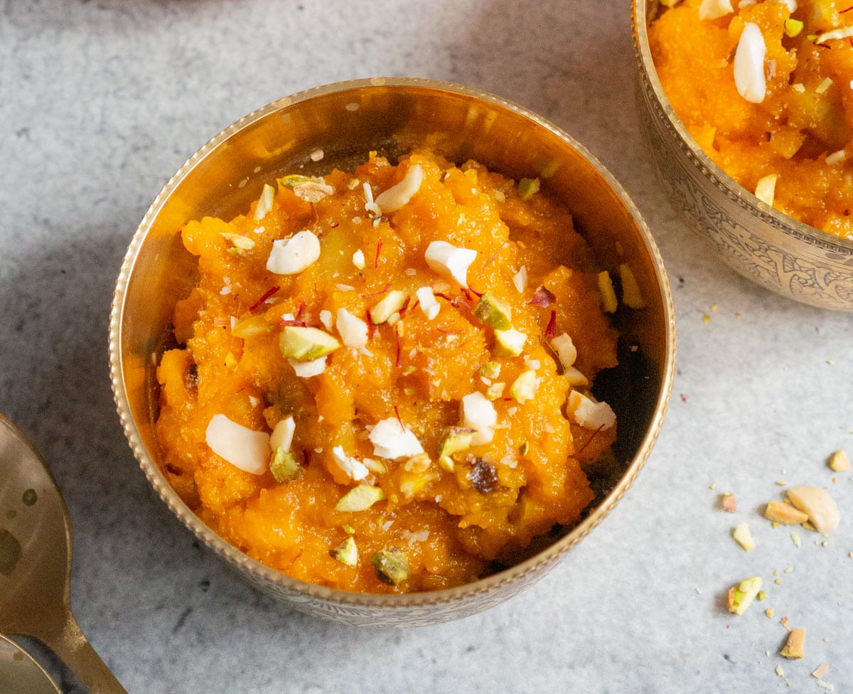 Coconut Pumpkin Halwa served in a bowl garnished with almonds and pistachios.